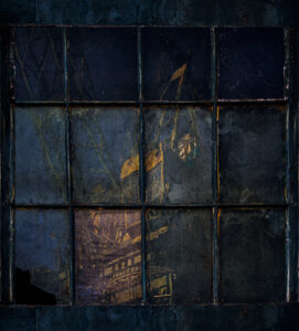 Reflection of a crane in an old window at Mare Island Shipyard